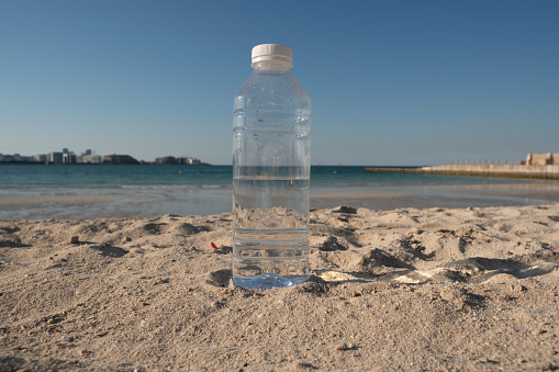 Closeup to bottle of water on the beach