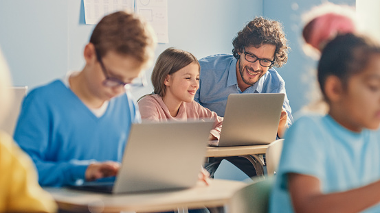 Computer Science Classroom 2024 Elementary School Computer Science Class Smart Girl Uses Laptop ...
