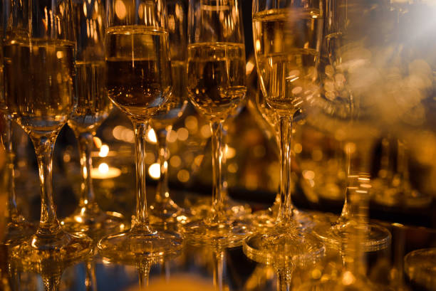 istock Glasses with champagne on the table, different focus, warm brown tinted 1254051680