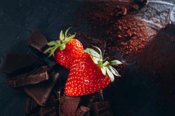 istock A few strawberries with chocolate and cocoa on a dark background 1254053586
