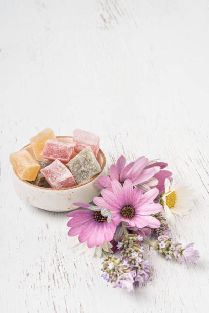 istock Turkish delights and flowers on a wooden table with copy space 1254054601