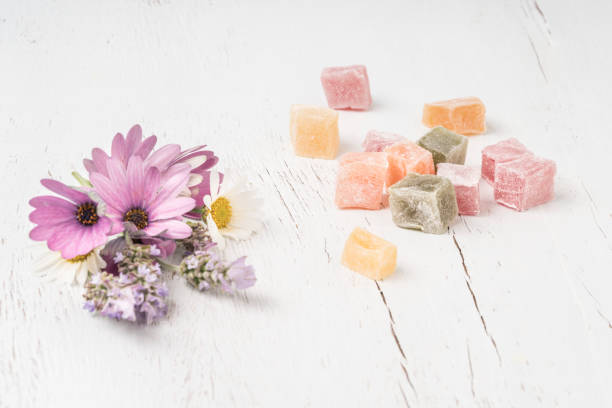 istock colorful Turkish delights and flowers on table with copy space 1254054602