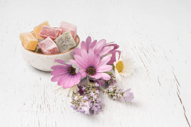 istock colorful Turkish delights and spring flowers on table with copy space 1254054605