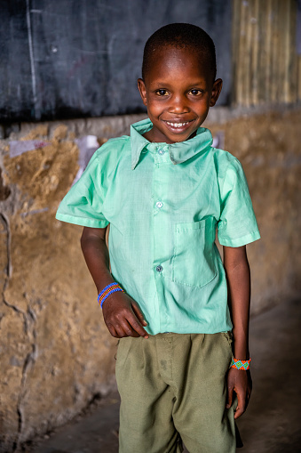 Portrait of African schoolboy in the school near Masai Mara Game Reserve in Kenya, East Africa