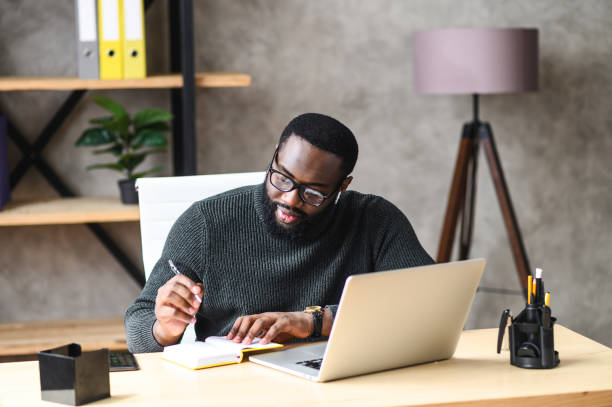istock An African-American guy using laptop in the office 1254062246