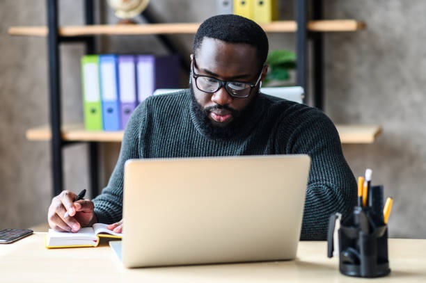istock An African-American guy using laptop in the office 1254062255