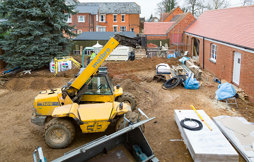 Buckingham, UK - December 02, 2016. Building work, construction site with heavy machinery on a heritage house renovation project, UK
