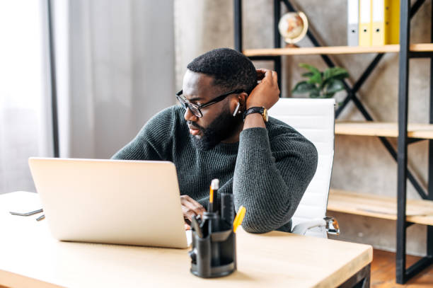 istock An African-American guy using laptop in the office 1254062267