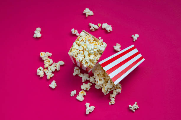 istock Overhead view of some popcorn on fuchsia background 1254063945