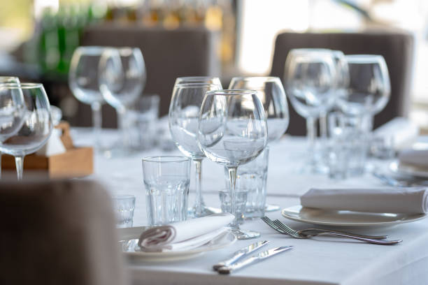 istock Empty glasses in restaurant background. Table set for an event party or wedding reception. 1254064112
