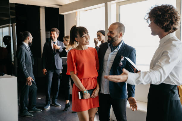 Wait staff of a luxury restaurant is welcoming business guests Wait staff of a luxury restaurant is welcoming business guests. Everyone is elegant to attend to an event. formal dinning stock pictures, royalty-free photos & images