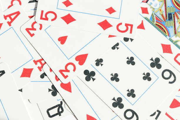 istock Many miscellaneous jumbled playing cards surface. Mixed playing cards background. Assorted play cards backdrop. 1254066780