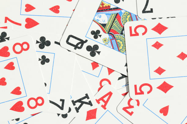 istock Assorted play cards backdrop. Many miscellaneous jumbled playing cards surface. Mixed playing cards background. 1254066782