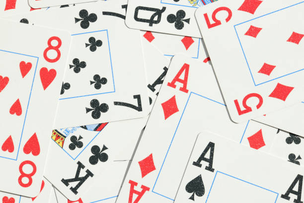 istock Many miscellaneous jumbled playing cards surface. Mixed playing cards background. Assorted play cards backdrop. 1254066817
