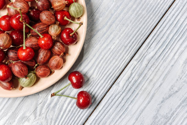 istock Plate with cherries and gooseberries 1254068036