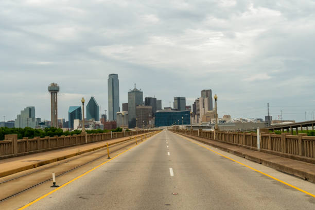 istock Dallas Skyline from Empty Highway With Dense Clouds on the Sky 1254068069