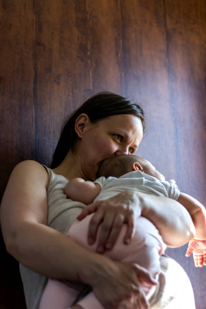 istock Shot of mother spending time with her newborn baby while is sleeping. 1254071037