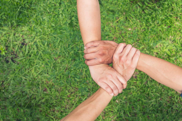 Three friends partner hand mission green background triangle partnership together banner template with copy space. Hands holding tight promise mission teamwork green ecology system web banner template