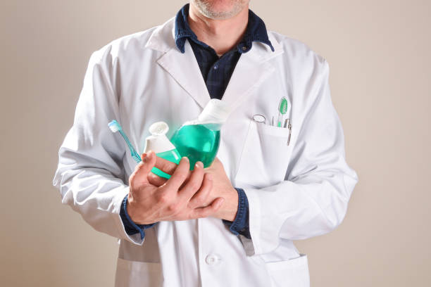 istock Dentist with oral hygiene tools and products half body general 1254073824