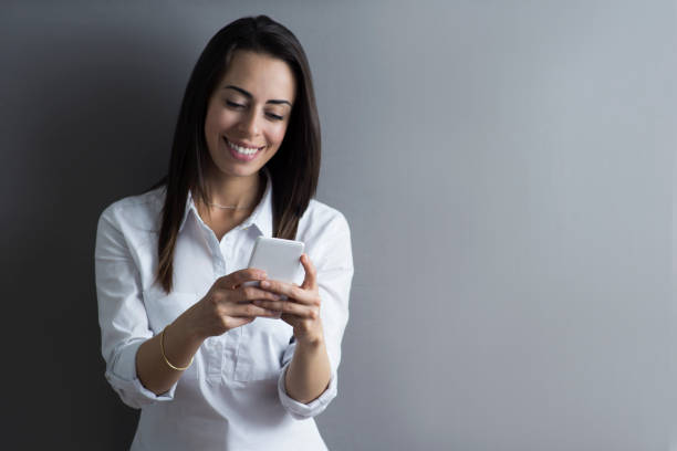 istock Businesswoman texting on smartphone very cheerfully 1254074074