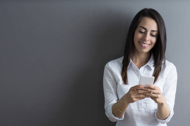 istock Relaxed businesswoman texting on smartphone looking happy 1254074096