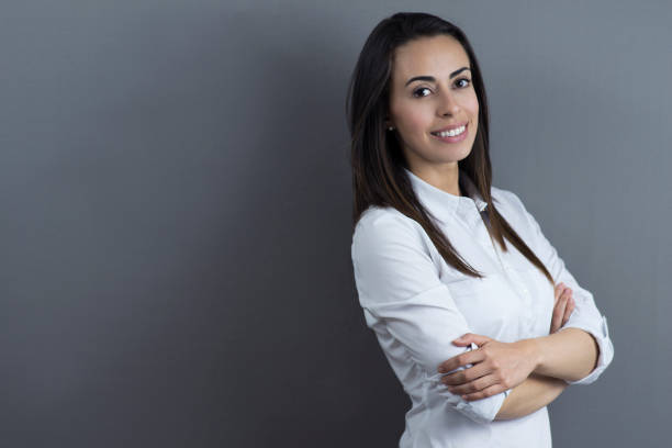 istock Young confident woman facing camera with arms crossed 1254074111