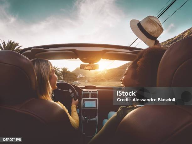 Happy Girls Doing Road Trip In Tropical City Travel People Having Fun Driving In Trendy Convertible Car Discovering New Places Friendship And Youth Girlfriends Vacation Lifestyle Concept Stock Photo - Download Image Now