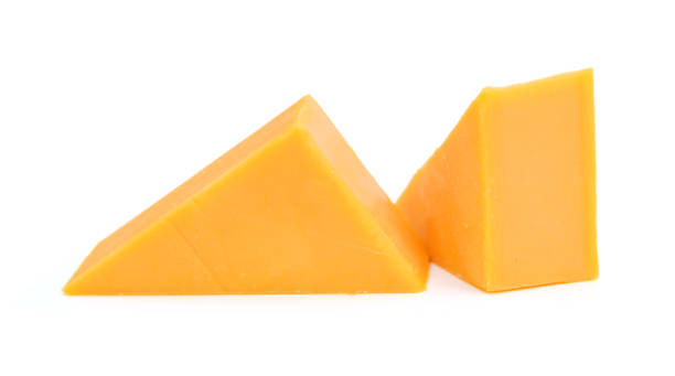 istock Cubes of cheddar cheese isolated on white 1254074277