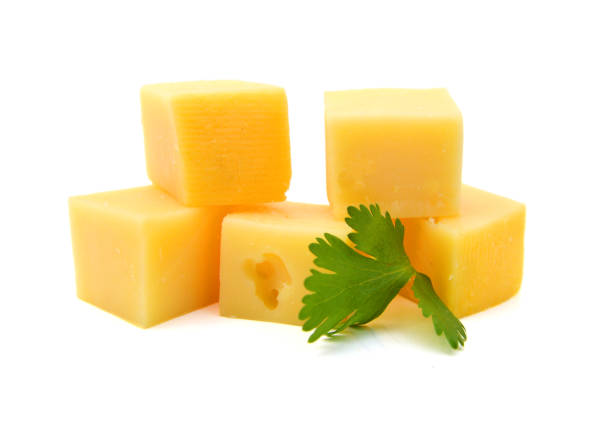 istock Cubes of cheddar cheese isolated on white 1254074343