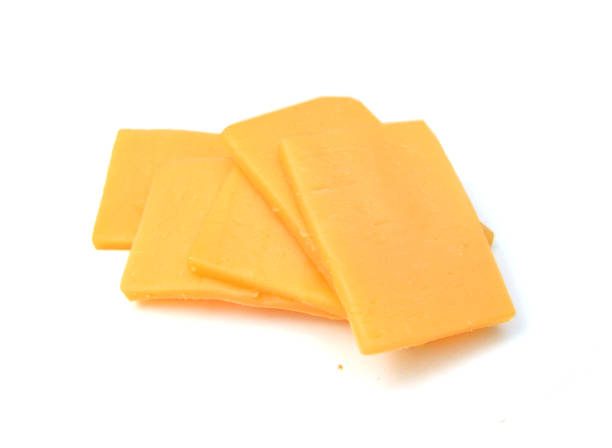 istock sliced of cheddar cheese isolated on white 1254075059