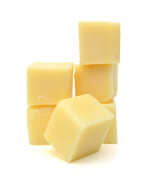 istock Cubes of cheddar cheese isolated on white 1254075091