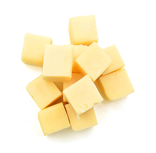 白で分離チェダーチーズのキューブ - dutch cheese 写真 ストックフォトと画像