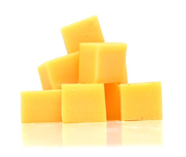 istock Cubes of cheddar cheese isolated on white 1254075204