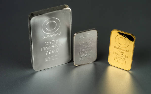 istock Gold and silver bars of different weight on a dark 1254075293