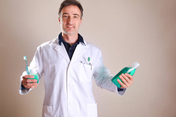 istock Dentist with oral hygiene tools and products general view 1254075365