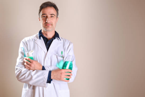 Uniformed dentist with dental tools with crossed hands