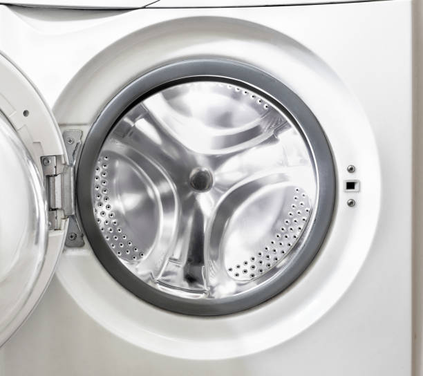 Open washing machine with empty white drum Open washing machine with empty white drum close-up washing machine drum stock pictures, royalty-free photos & images