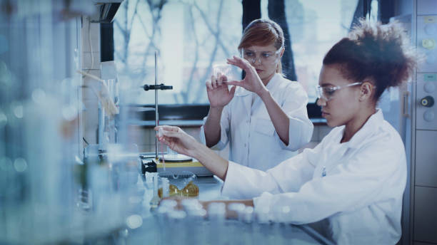 Multi ethnic female team studying DNA mutations. Virtual touch screens Scientists examines DNA models in modern Neurological Research Laboratory. Touch screens genetic screening stock pictures, royalty-free photos & images