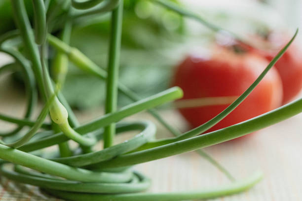 vegetables on a wooden kitchen board, green onions, dill and peas, sliced cabbage on a wood background, concept of fresh and healthy food, still life
