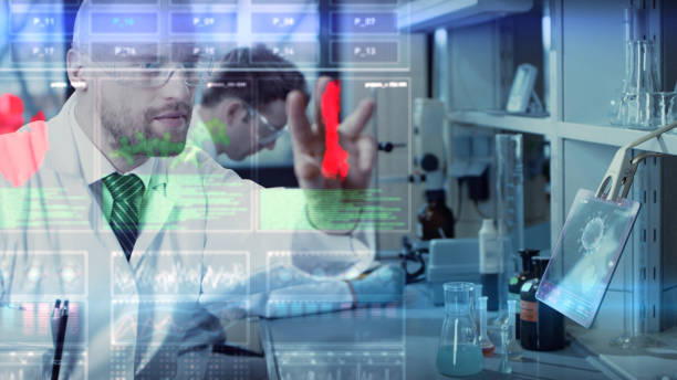 istock COVID-19 - laboratory team working on coronavirus vaccine. Touch screens 1254080450