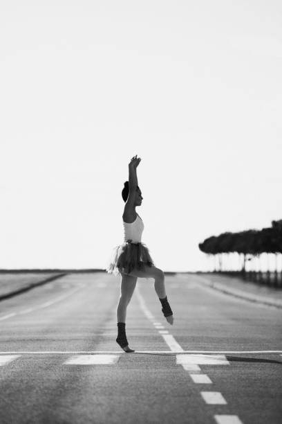istock Beautiful ballet dancer posing at street 1254083497