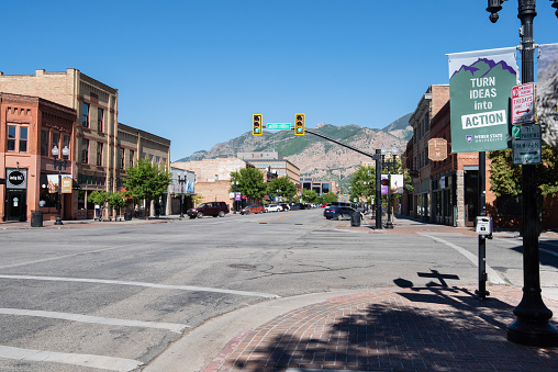 Odgen, Utah USA June 22, 2020 - The corner of Lincoln Avenue and Historic 25th street. Shops and restaurants line the street while the Wasatch Range of the Rocky Mountains loom in the background.