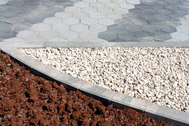 istock Grey hexagonal cobblestone path divided with pebbles and soil for later planting. Urban planning. 1254088259