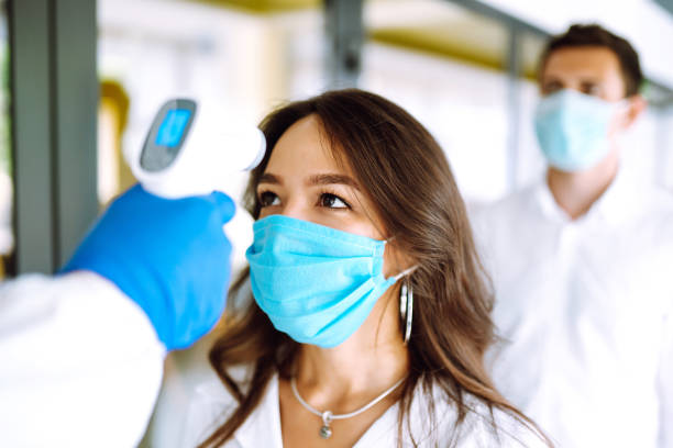 istock Visitors must go through fever measures using infrared digital thermometer check temperature measurement on the forehead. 1254089879