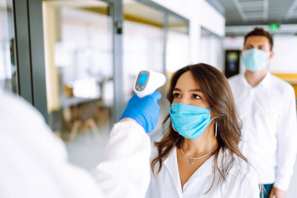 istock Visitors must go through fever measures using infrared digital thermometer check temperature measurement on the forehead. 1254089908