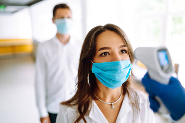 istock Visitors must go through fever measures using infrared digital thermometer check temperature measurement on the forehead. 1254089910