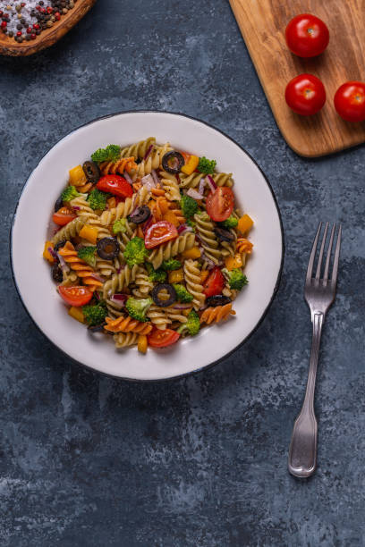 istock Pasta salad with tomato, broccoli, black olives 1254090835