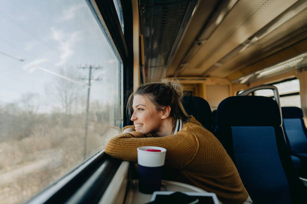 istock Smiling woman on a train 1254092047
