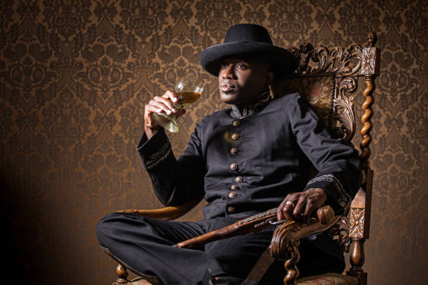 African traditionally dressed european man with a weapon Handsome traditional dutch black man wearing historically correct outfit holding a gun in a typical townhouse drawing room rich black men pictures stock pictures, royalty-free photos & images