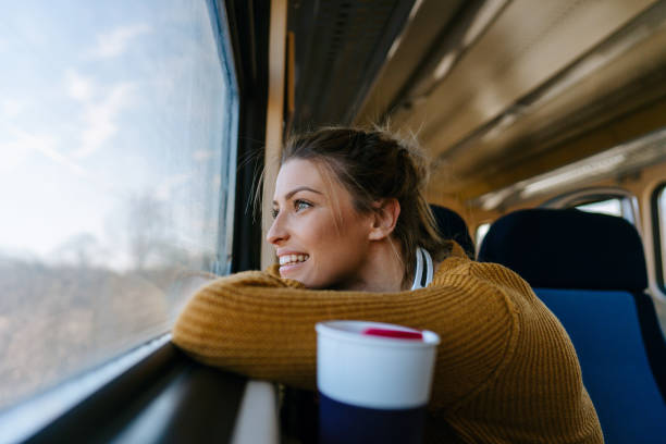 istock Smiling woman on a train 1254092371